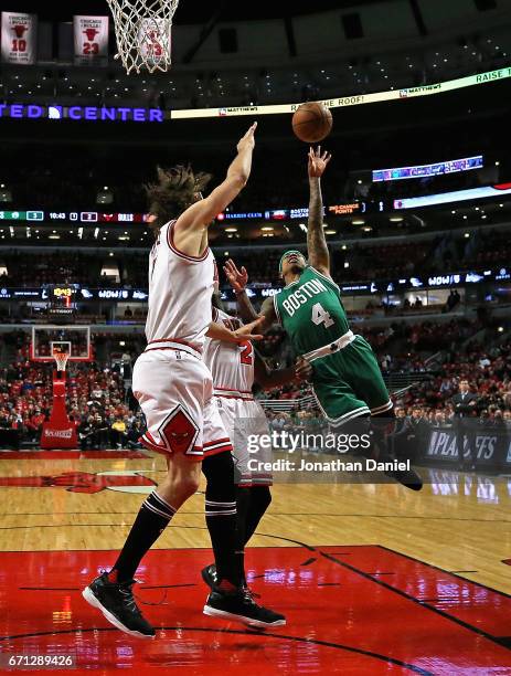 Isaiah Thomas of the Boston Celtics drives against Jerian Grant and Robin Lopez of the Chicago Bulls during Game Three of the Eastern Conference...