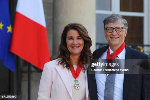Bill and Melinda Gates pose in front of the Elysee Palace after receiving the award of Commander of the Legion of Honor by French President Francois...