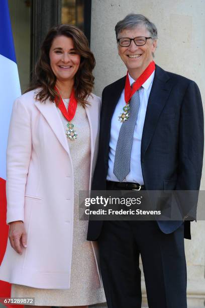 Bill and Melinda Gates pose in front of the Elysee Palace after receiving the award of Commander of the Legion of Honor by French President Francois...