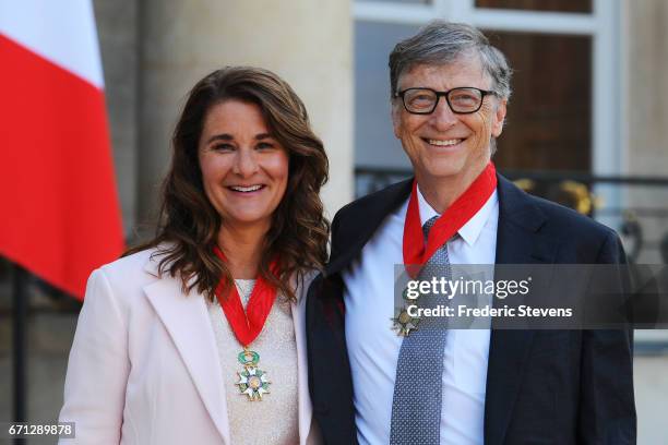 Bill and Melinda Gates pose in front of the Elysee Palace after receiving the award of Commander of the Legion of Honor by French President Francois...