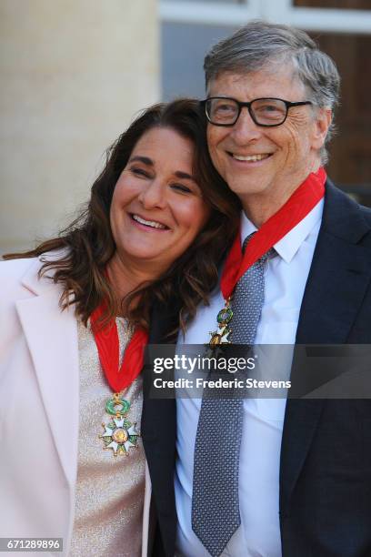 Bill and Melinda Gates pose in front of the Elysee Palace after receiving the award of Commander of the Legion of Honor by French President Francois...