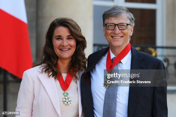 Bill and Melinda Gates pose in front of the Elysee Palace after receiving the award of Commander of the Legion of Honor by French President Francois...