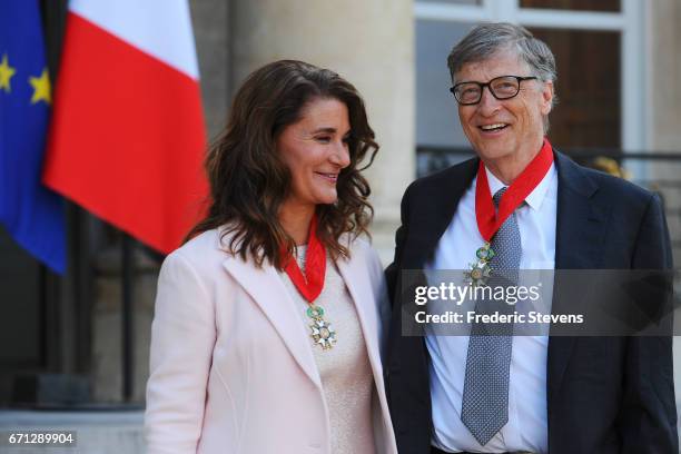 Bill and Melinda Gates pose in front of the Elysee Palace after receiving the award of Commander of the Legion of Honor by French President Francois...