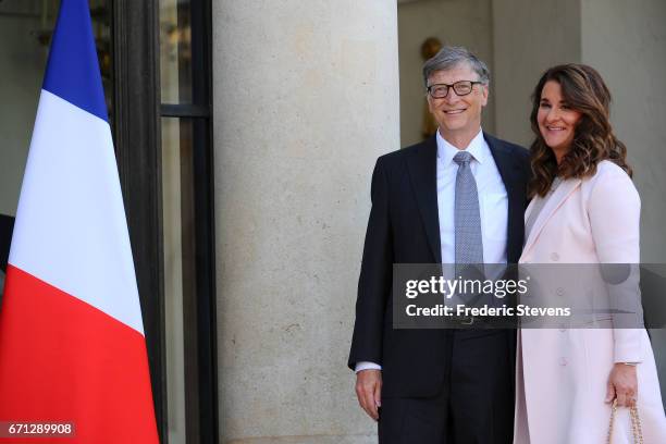 Bill and Melinda Gates pose in front of the Elysee Palace before receiving the award of Commander of the Legion of Honor by French President Francois...