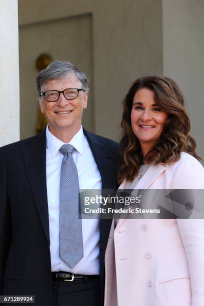 Bill and Melinda Gates pose in front of the Elysee Palace before receiving the award of Commander of the Legion of Honor by French President Francois...