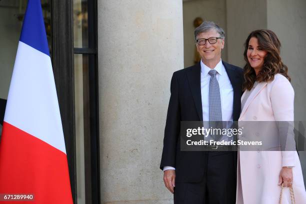 Bill and Melinda Gates pose in front of the Elysee Palace before receiving the award of Commander of the Legion of Honor by French President Francois...