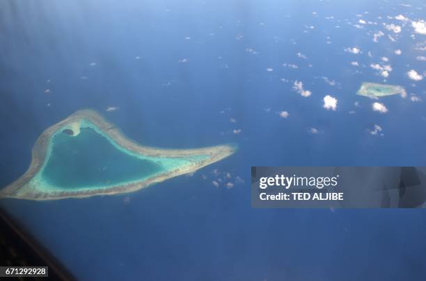 This picture taken on April 21, 2017 shows an aerial view of reefs in the disputed Spratly islands. - Philippine Defence Secretary Delfin Lorenzana...