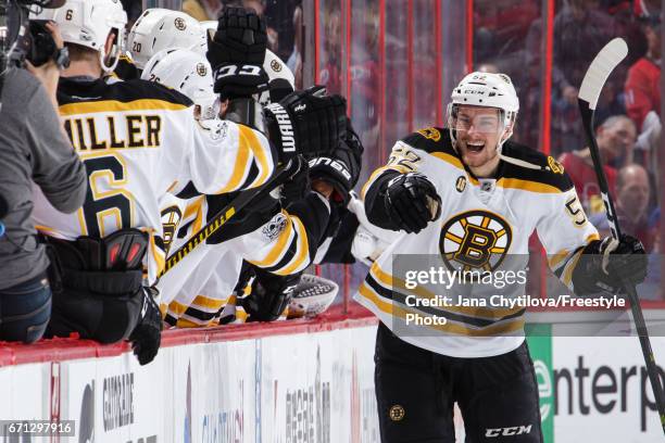 Sean Kuraly of the Boston Bruins celebrates his second period goal against the Ottawa Senators with teammates on the bench in Game Five of the...