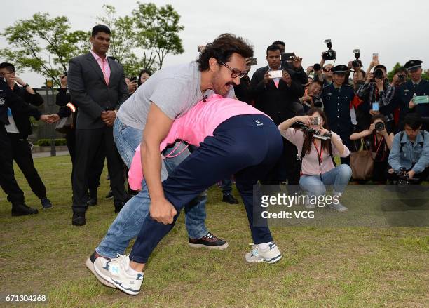 Bollywood actor Aamir Khan wrestles with a female wrestler at Mount Qingcheng on April 20, 2017 in Chengdu, China.