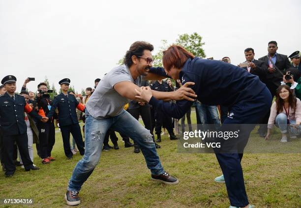 Bollywood actor Aamir Khan wrestles with a female wrestler at Mount Qingcheng on April 20, 2017 in Chengdu, China.