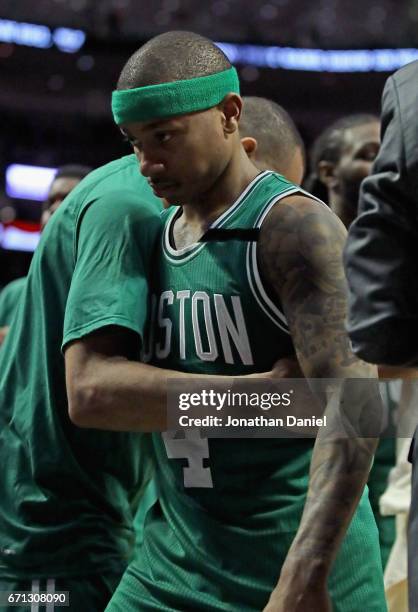 Isaiah Thomas of the Boston Celtics gets a hug from a teammate as he leaves the floor following a win over the Chicago Bulls during Game Three of the...