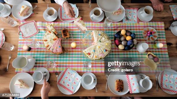 overhead view on easter table with family around - easter cake stock pictures, royalty-free photos & images