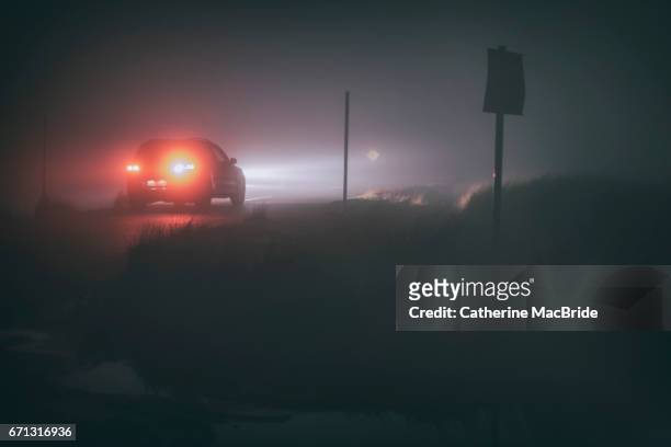 driving in thick fog at night - catherine macbride stock pictures, royalty-free photos & images