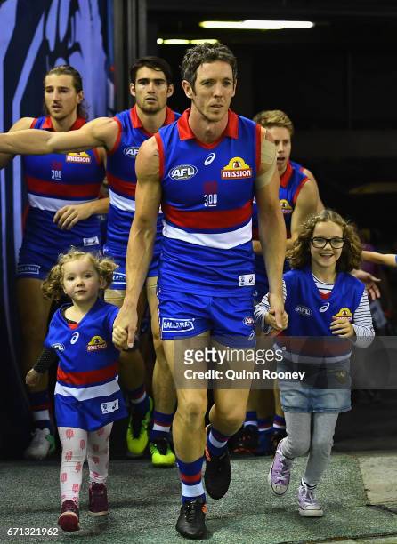 Robert Murphy of the Bulldogs leads his team out for his 300th game during the round five AFL match between the Western Bulldogs and the Brisbane...