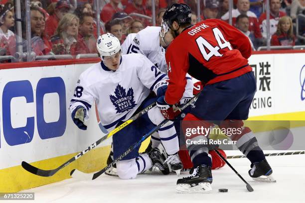 Kasperi Kapanen of the Toronto Maple Leafs and Brooks Orpik of the Washington Capitals go after the puck in Game Five of the Eastern Conference First...