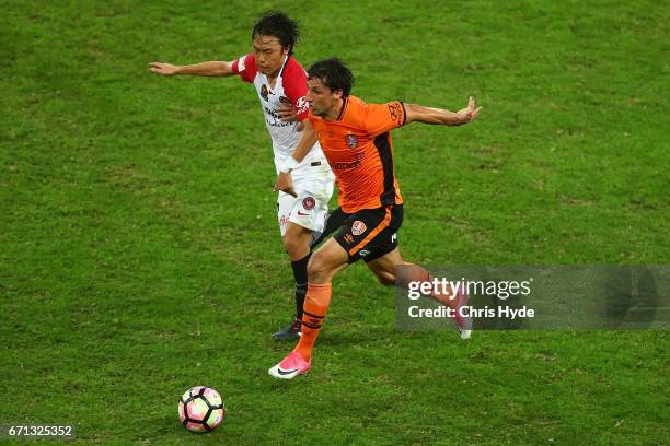 Thomas Broich of the Roar and Jumpei Kusukami of the Wanderers compete for the ball during the A-League Elimination Final match between the Brisbane...