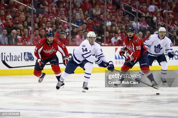 Auston Matthews of the Toronto Maple Leafs passes the puck in front of Marcus Johansson of the Washington Capitals in Game Five of the Eastern...