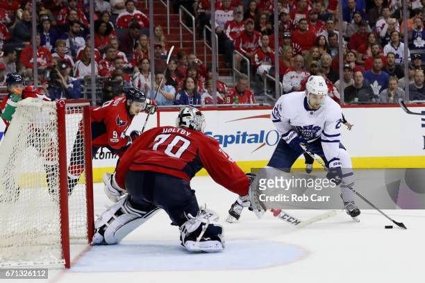 James van Riemsdyk of the Toronto Maple Leafs takes a shot on goalie Braden Holtby of the Washington Capitals in Game Five of the Eastern Conference...