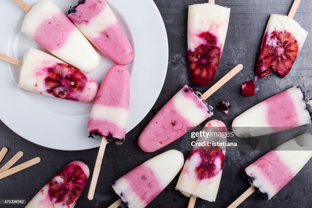 Food background.  Homemade berry yogurt ice pops with frozen black currant