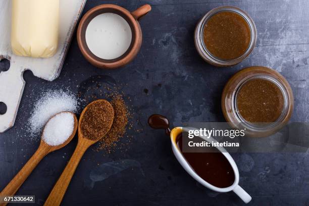 homemade caramel sauce in  glass jars and ingredients - sugar jar stock pictures, royalty-free photos & images