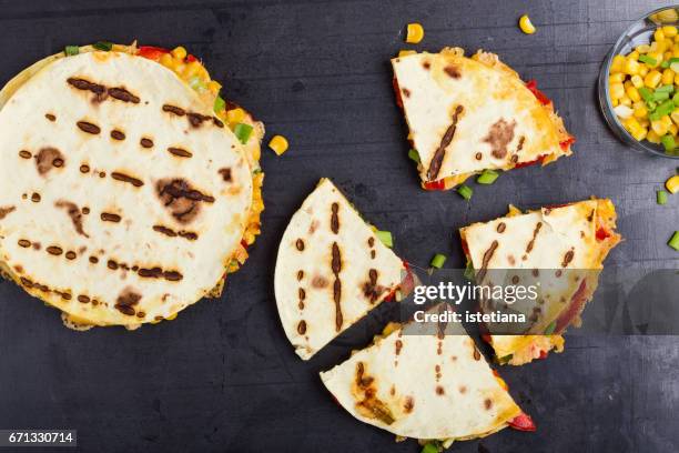 quesadillas with corn and red bell pepper cut into wedges - tortilla stock pictures, royalty-free photos & images