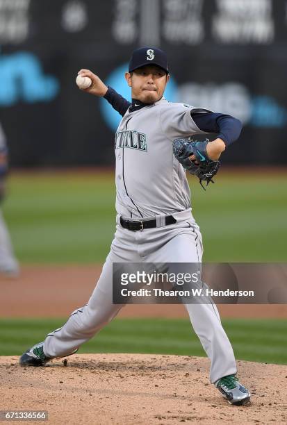 Hisashi Iwakuma of the Seattle Mariners pitches against the Oakland Athletics in the bottom of the first inning at Oakland Alameda Coliseum on April...