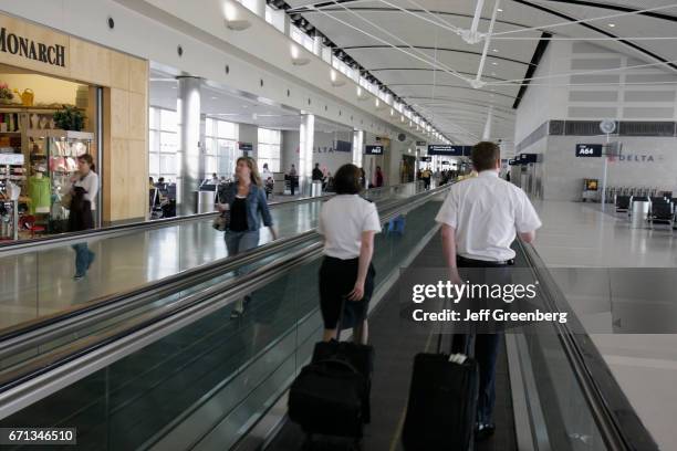 Flight crew on the automated walkway at Detroit Metropolitan Wayne County Airport.