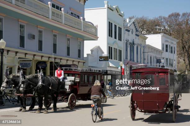 Horse-drawn carriages on Main street at Mackinac Historic State Parks Park.