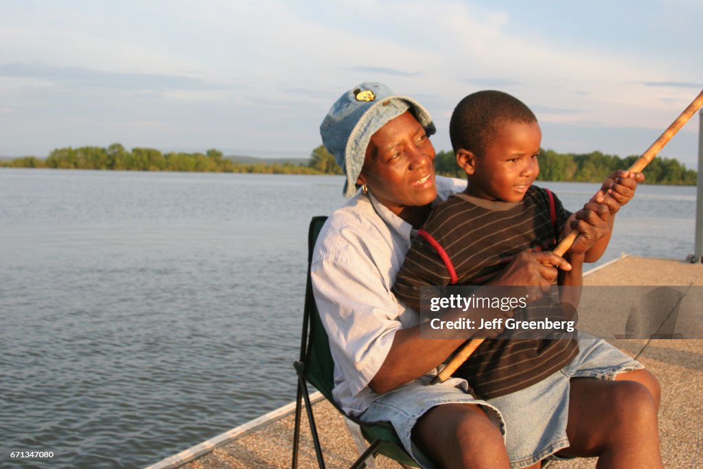 A grandmother and her grandson fishing in Chattahoochee River.