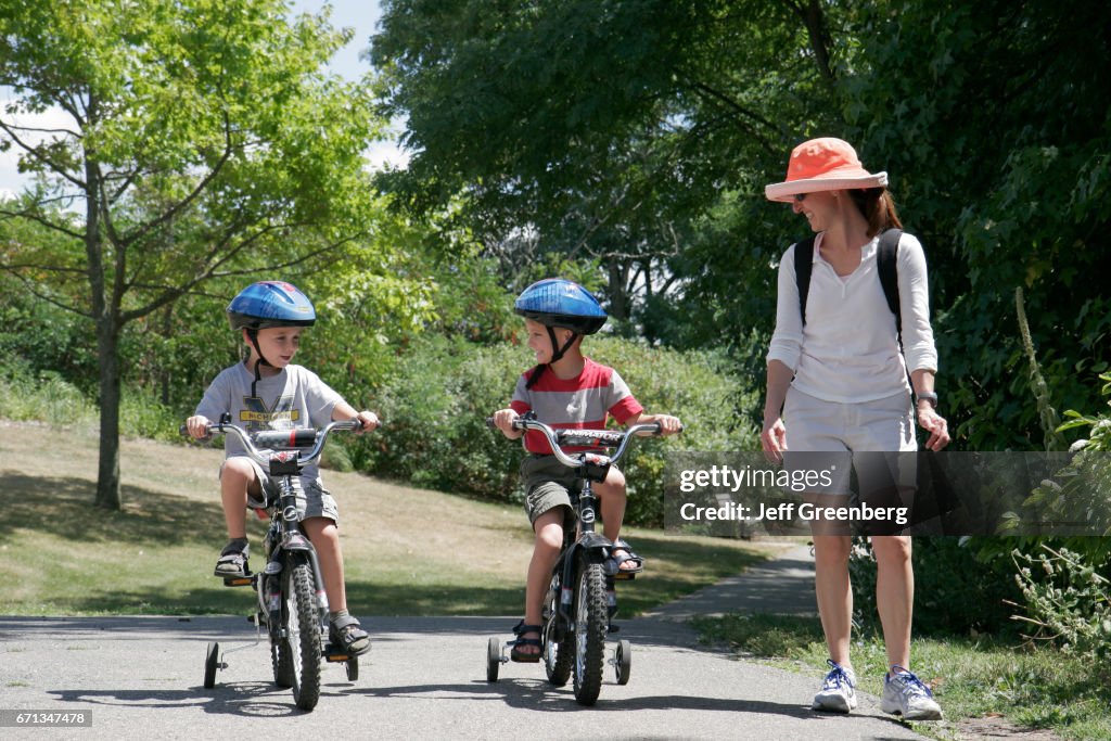 Two boys riding training bicycles at Gallup Park.