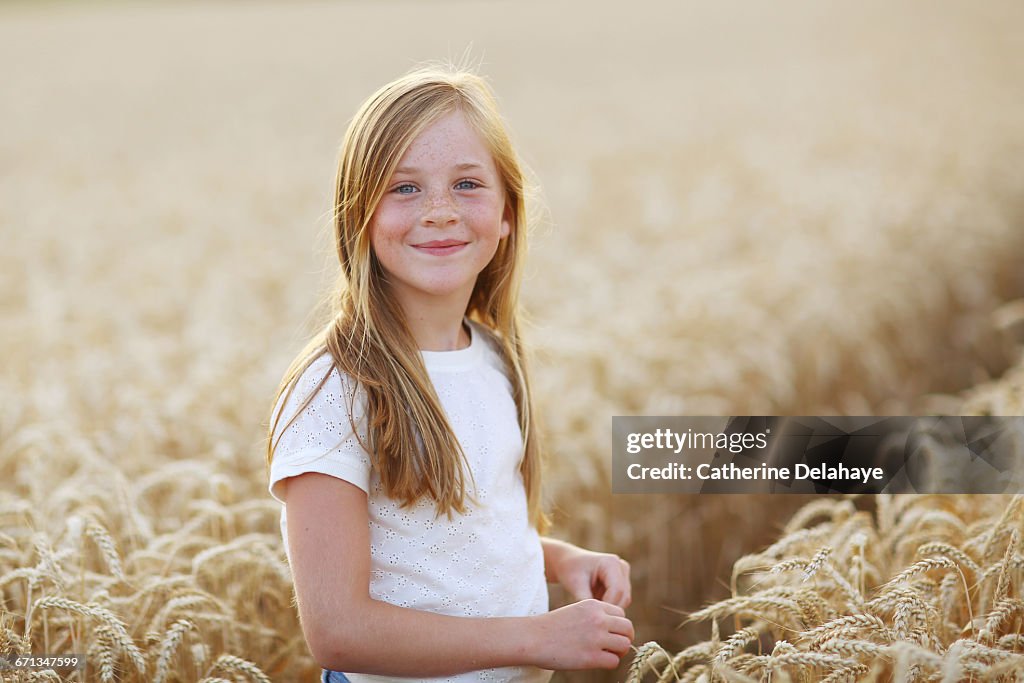A 8 years old girl in a wheat field