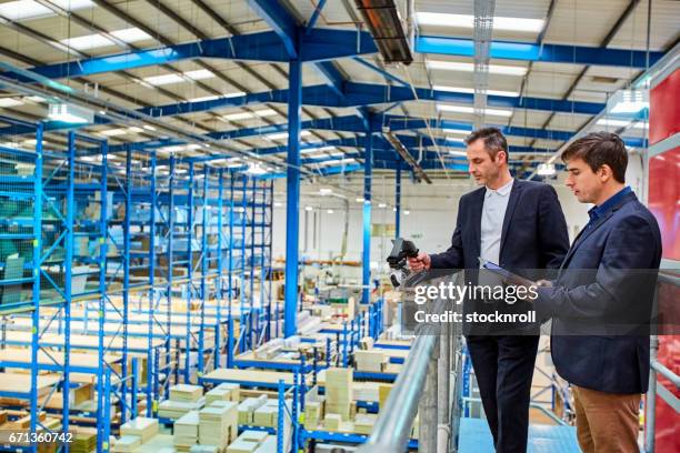 business colleagues testing a cctv camera in factory - looking over balcony stock pictures, royalty-free photos & images