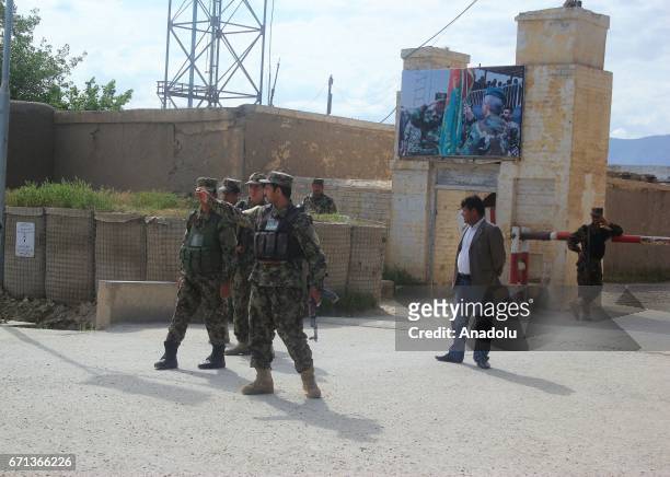 Afghan security officials are seen after ambulances carry people, who got wounded on Taliban fighters' attack to the 209th Corps, to hospitals in...