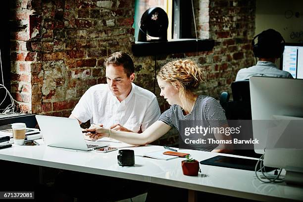 business partners discussing project on laptop - digital trust stock pictures, royalty-free photos & images