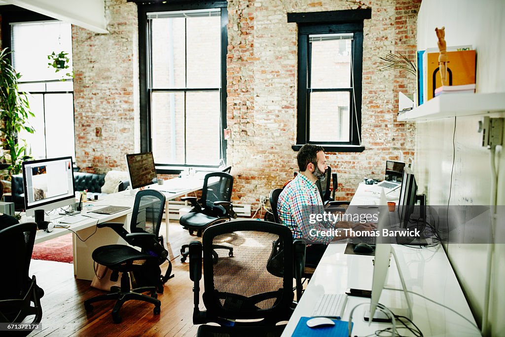 Program Developer Coding At Desk In Empty Office High-Res Stock Photo ...