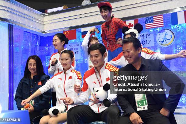 Cheng Peng and Yang Jin of China reacts with their team mates at the kiss and cry after the Pairs free skating during the 3rd day of the ISU World...