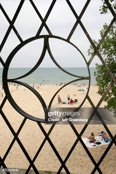 Public beach seen through a metal grid at Indiana Dunes State Park.