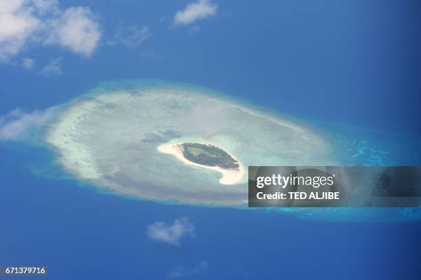 This photo taken on April 21, 2017 shows an aerial shot of a reef in the disputed Spratly islands on April 21, 2017. Philippine Defence Secretary...