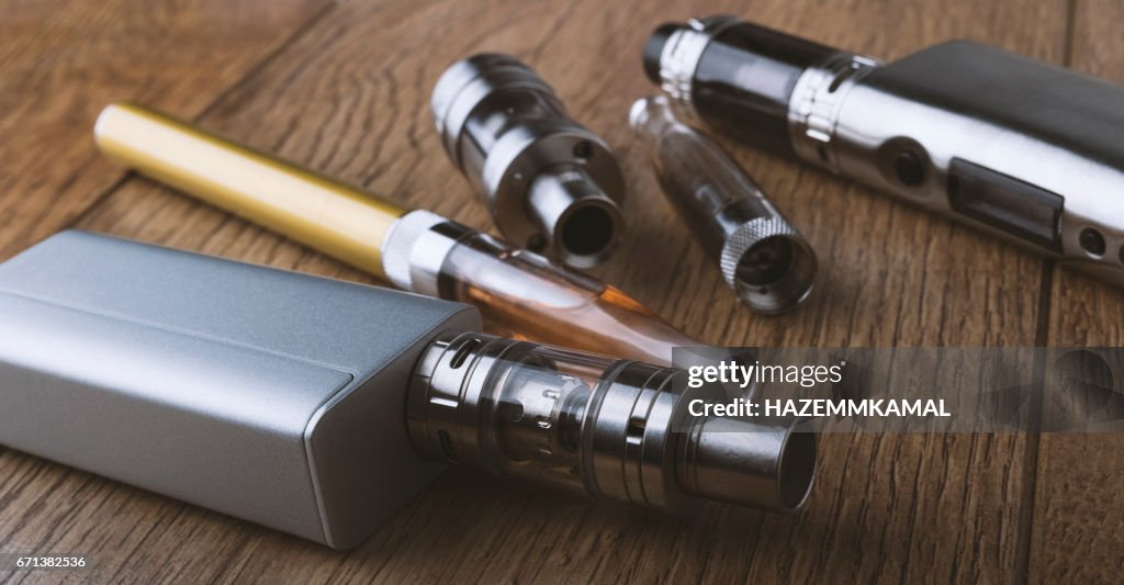 Vape pen, mod, e cigarette, e-cig, on a wooden background.