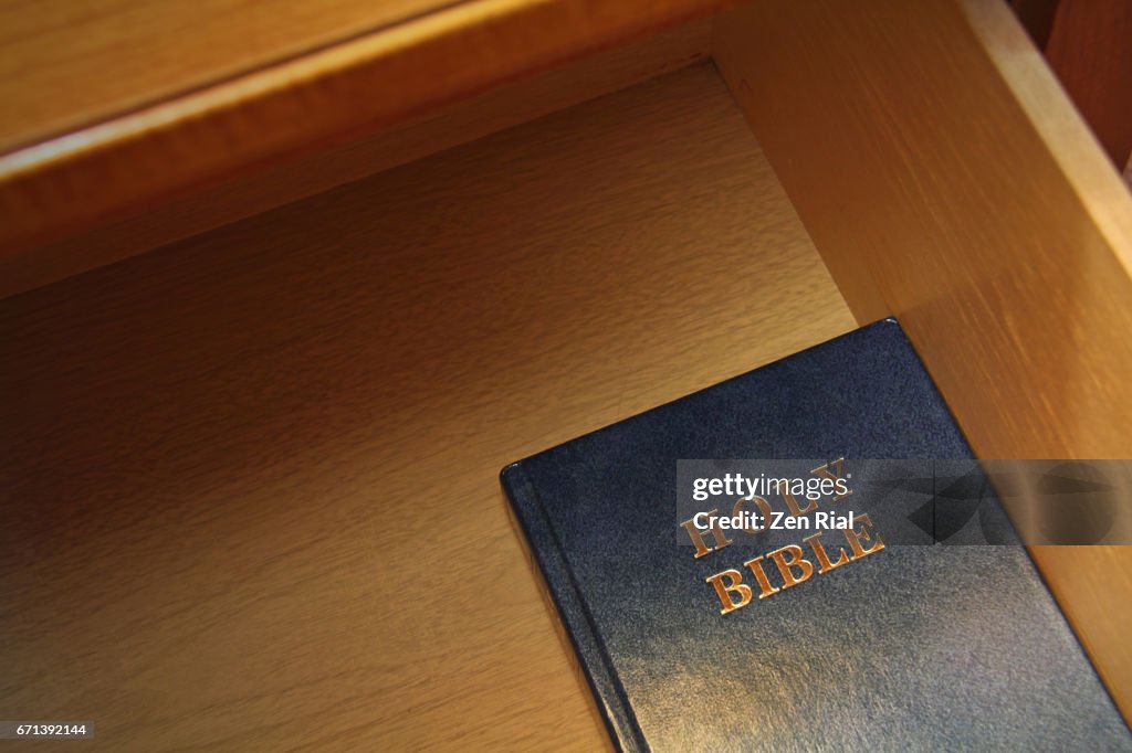 Holy Bible inside an open drawer of a night table in a hotel