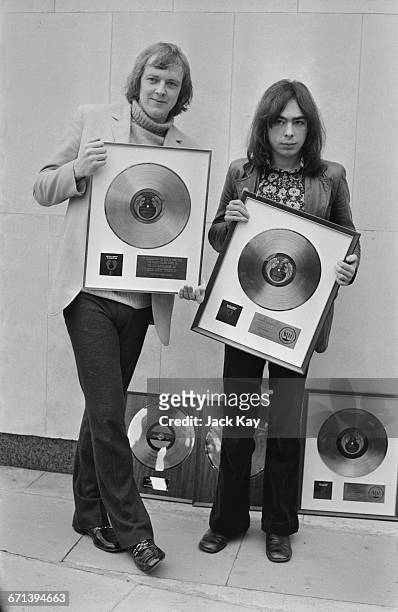 Lyricist Tim Rice and composer Andrew Lloyd Webber, with their awards to commemorate the sale of more than two million dollars worth of the...