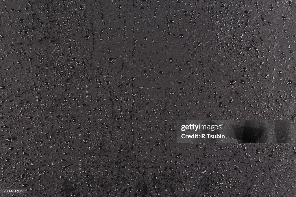 Water drops on dark stone