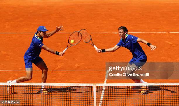 Pierre-Hughes Herbert and Nicolas Mahut of France in action against Marc Lopez and Feliciano Lopez of Spain in their semi final doubles match on day...