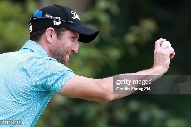 Gregory Bourdy of France celebrates for playing a Hole-In-One shot at Tee No.3 during the third round of the Shenzhen International at Genzon Golf...