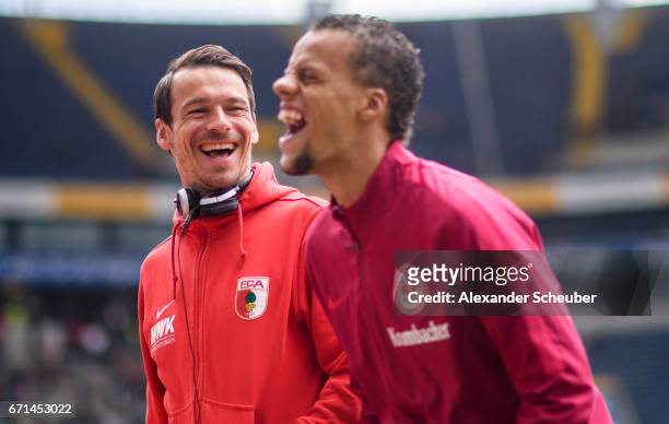 Markus Feulner of Augsburg and Timothy Chandler of Frankfurt laugh together during the Bundesliga match between Eintracht Frankfurt and FC Augsburg...