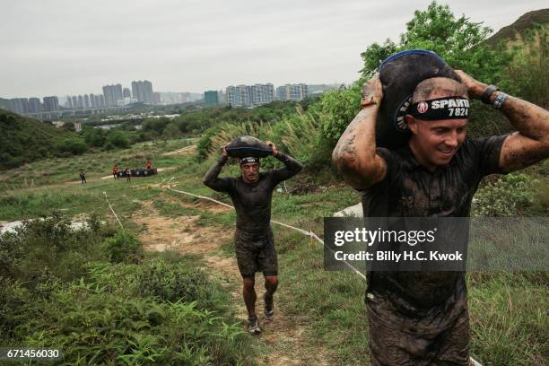 Competitors carry the sand bags during the Spartan Race Asia-Pacific on April 22, 2017 in Hong Kong, Hong Kong. Thousands of competitors from over 20...