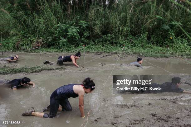 Competitors participate the Barbed Wire Crawl task during the Spartan Race Asia-Pacific on April 22, 2017 in Hong Kong, Hong Kong. Thousands of...