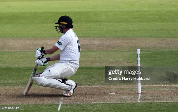 Luke Wright of Sussex is bowled by Jake Ball of Nottinghamshire during Day Two of the Specsavers County Championship Division Two match between...