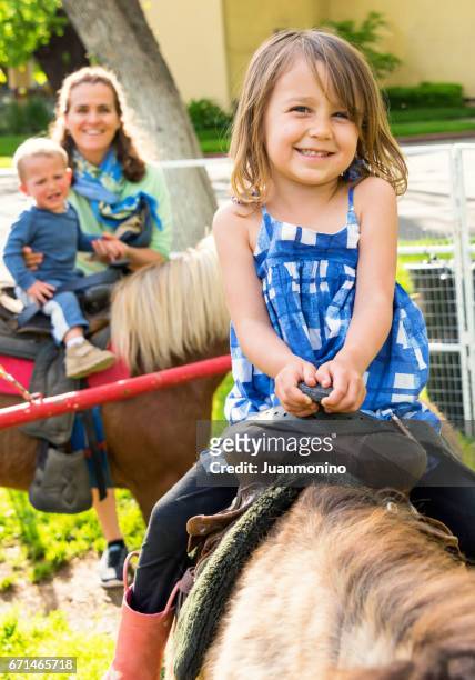 mature woman having fun with her children - pony stock pictures, royalty-free photos & images