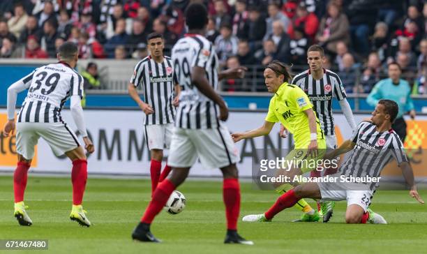 Takashi Usami of Augsburg challenges Timothy Chandler of Frankfurt during the Bundesliga match between Eintracht Frankfurt and FC Augsburg at...